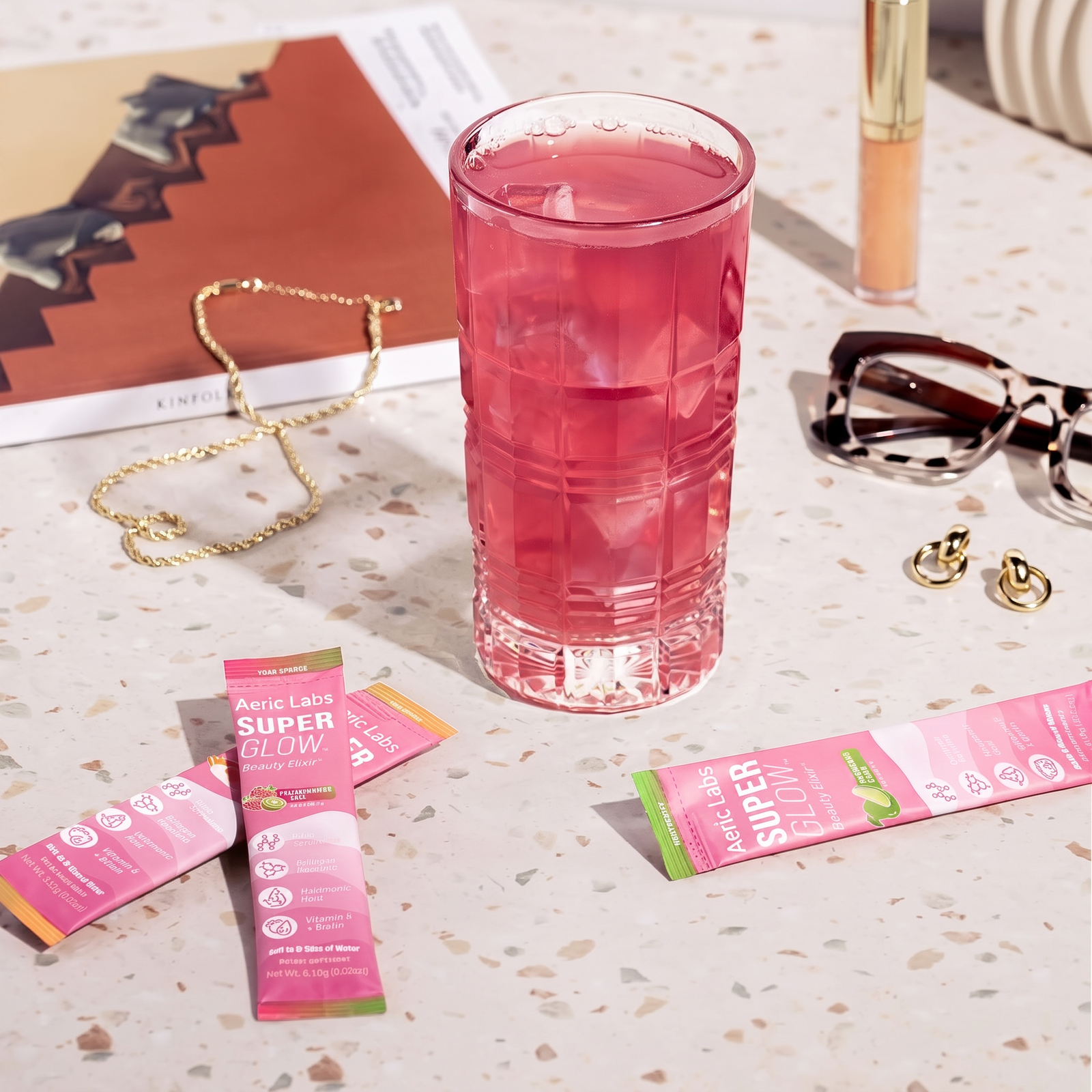 Superglow sticks on a terrazzo counter with the mixed drink